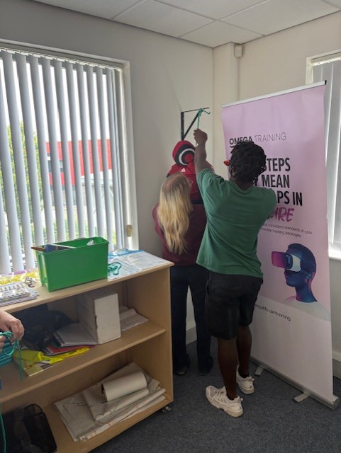 Care staff setting up moving and handling equipment at an Omega Training session