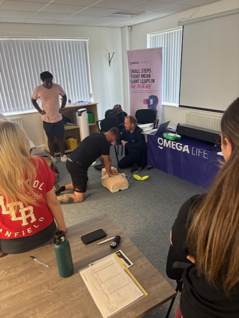 Care staff taking part in a hands-on CPR and first aid training session