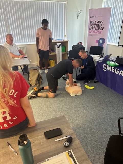Learners practising CPR on training manikins